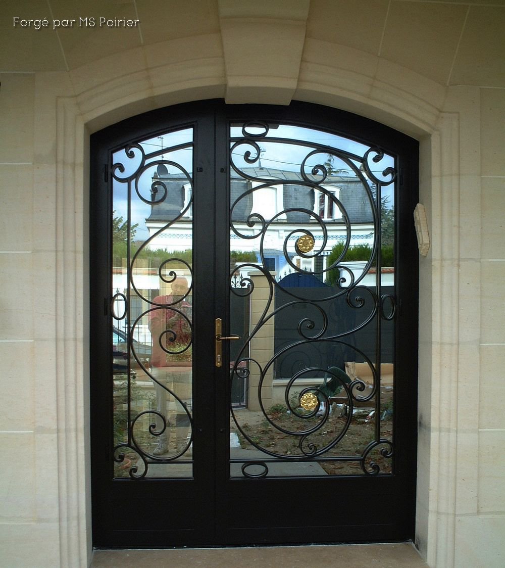 Porte d'entrée en fer forgé avec un linteau cintré